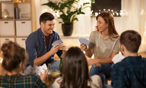 Couple hosting a game night with friends