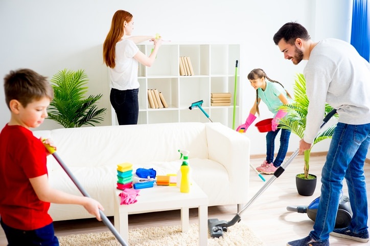 A Happy Family of Four Is Cleaning Their House